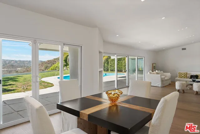 a kitchen with stainless steel appliances granite countertop a stove a sink dishwasher a refrigerator and cabinets with wooden floor