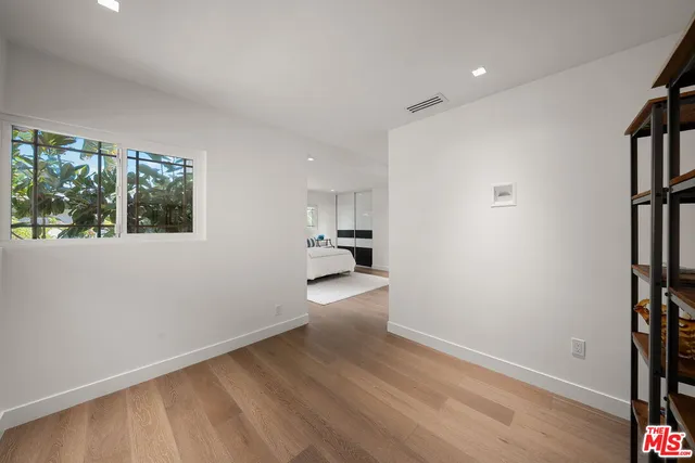 a bedroom with furniture and window