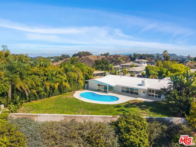 a view of house with outdoor space and swimming pool