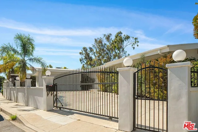 a view of a big yard with potted plants