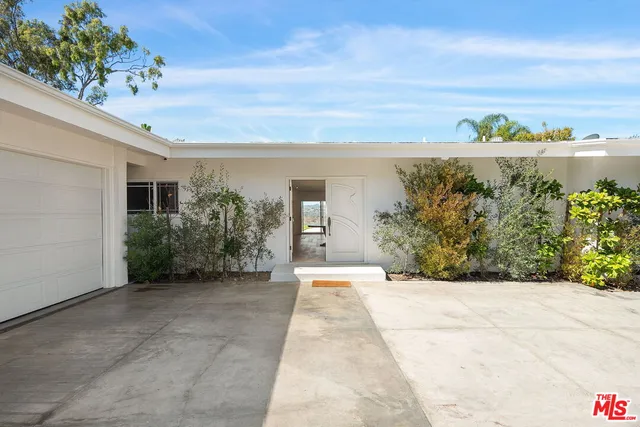 a living room with furniture a window and a wooden floor