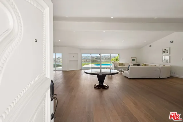 a living room with furniture and a large window with outer view