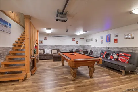 a room with lots of furniture and wooden floor