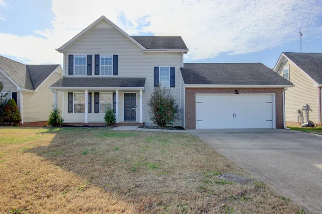 a front view of a house with a yard and garage