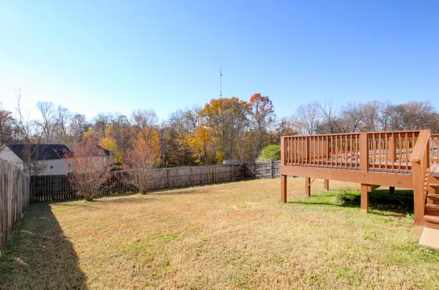 a view of a terrace with a bench and trees around