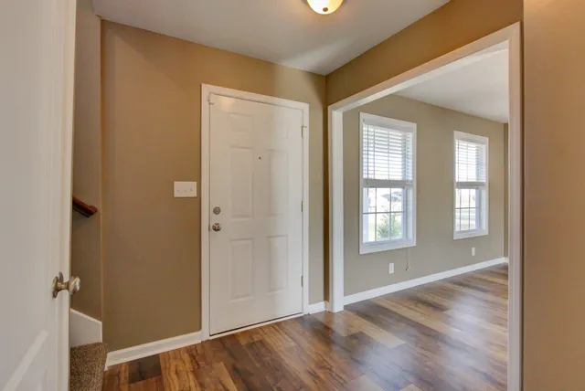 an empty room with windows and closet