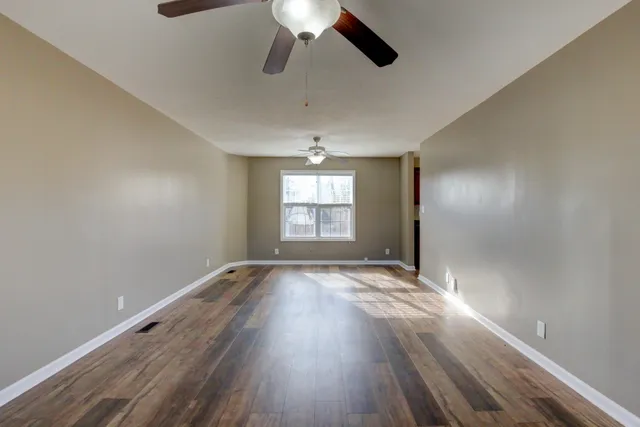 wooden floor in an empty room with a window