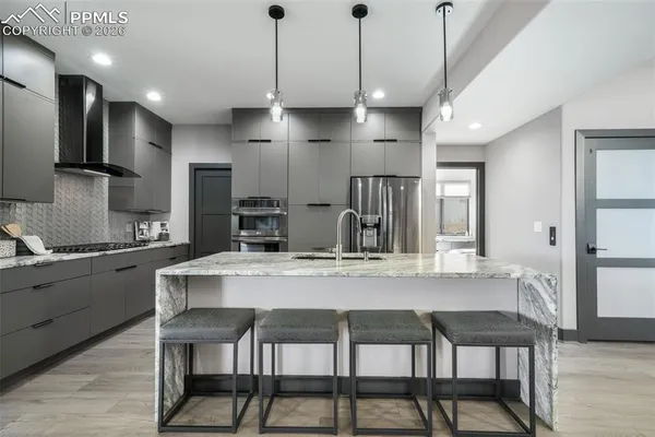 a kitchen with kitchen island granite countertop a table and chairs in it