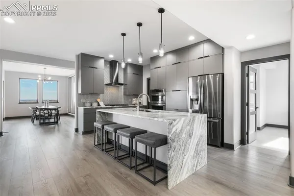 a large kitchen with a table and chairs