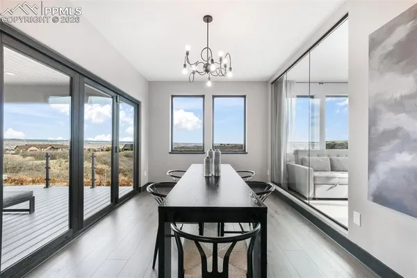 a view of a dining room with furniture large windows and wooden floor