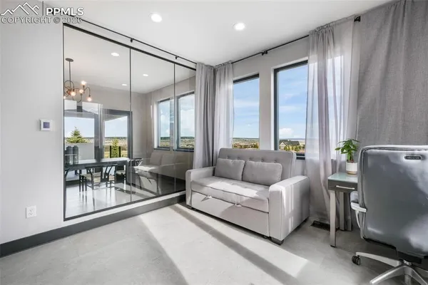 a living room with furniture and a chandelier