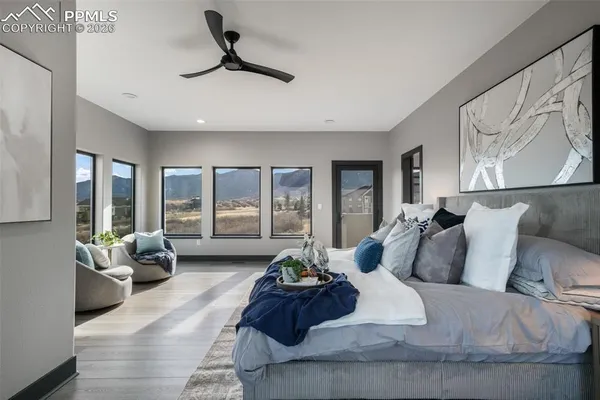a bed sitting in a bedroom next to a large window
