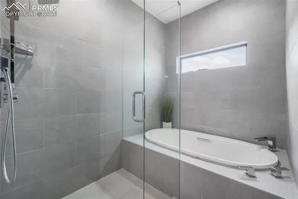 a en suite bathroom with a sink a mirror and next to a window