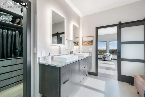 a bedroom with a large bed and a flat screen tv
