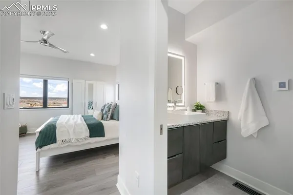 a bedroom with a bed and a lamp