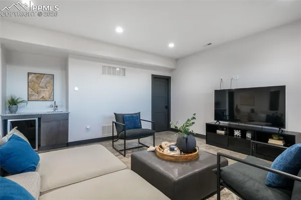 a living room with furniture and view of kitchen