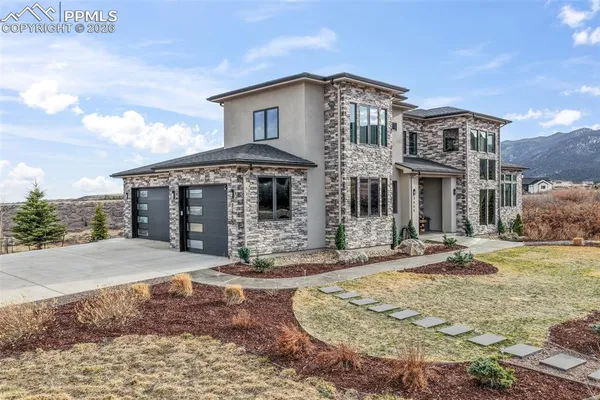 a front view of a house with garden and patio