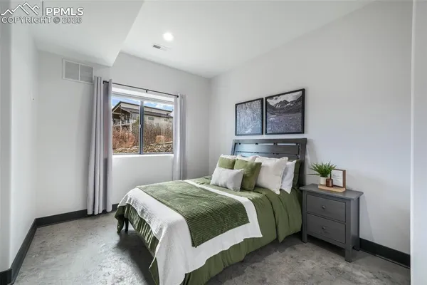 a bedroom with a bed and a lamp