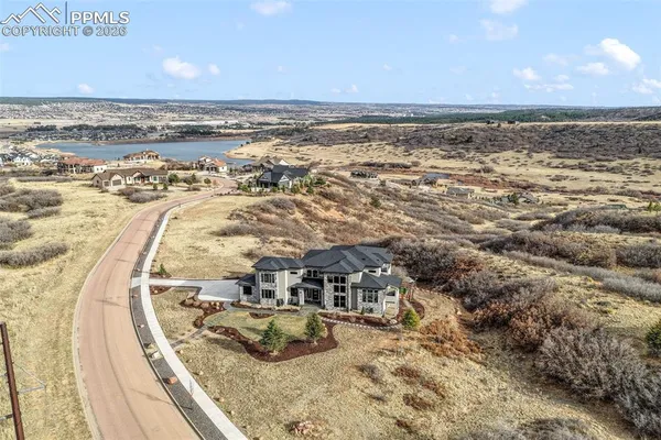 an aerial view of a house with a yard