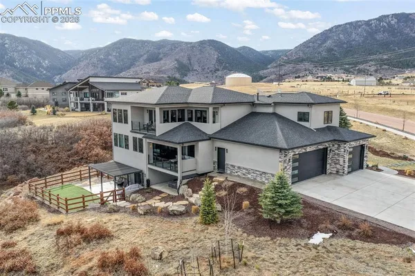 aerial view of a house with a yard and balcony