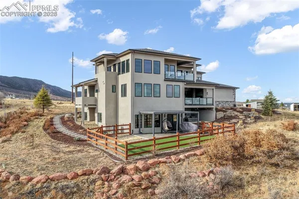 a view of a house with backyard and sitting area