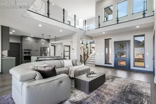 a living room with furniture and a view of kitchen