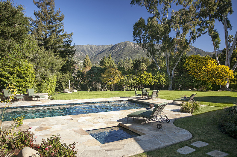 a view of a swimming pool and lounge chairs