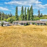 a house view with a swimming pool and trees in the background