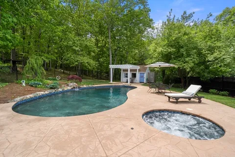 swimming pool view with a seating space