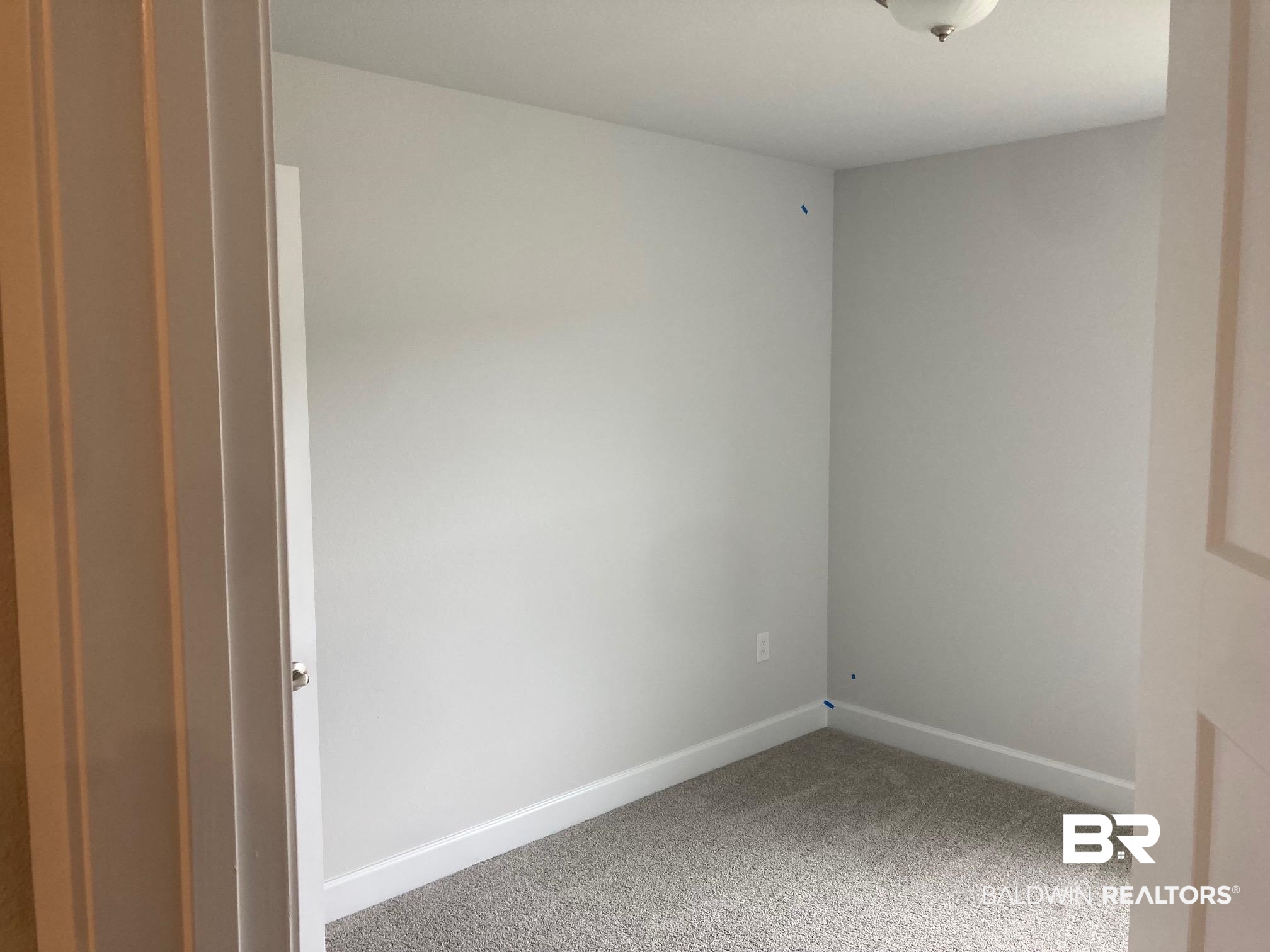 705 Mayflower Drive Foley, AL 36535 - Photo 13 of 19 Empty room featuring carpet flooring and baseboards