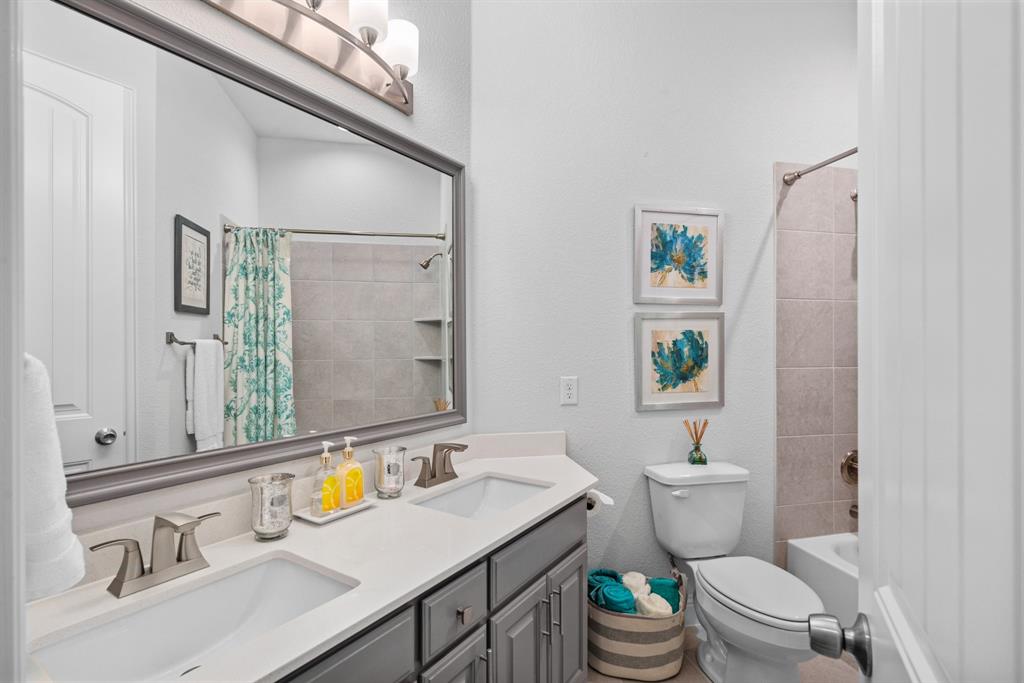 834 Rustic Trail Midlothian, TX 76065 - Photo 21 of 29 Secondary bathroom features double sinks with storage built in to vanity and a shower tub combo.