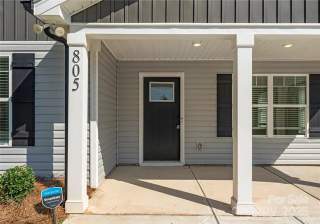 a front view of a house with a potted plant and garage