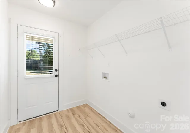 an empty room with window and ceiling fan