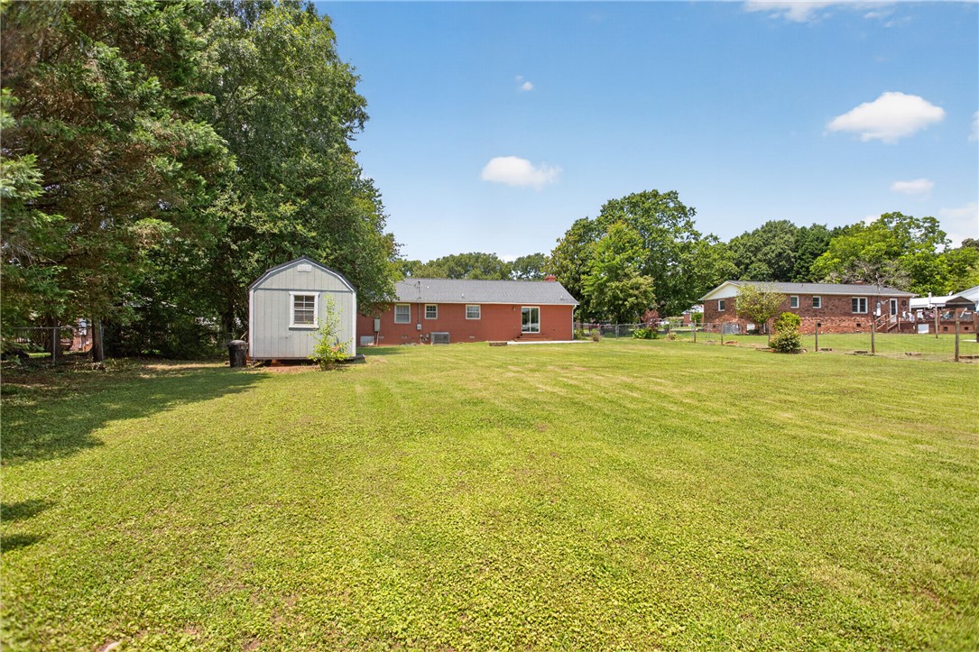 113 Greenfield Avenue Pendleton, SC 29670 - Photo 29 of 40 A sprawling lawn offers generous space for outdoor activities and future expansion.