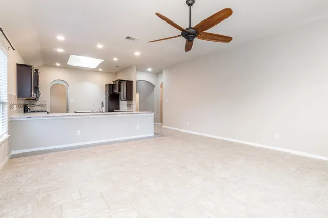 a view of a kitchen with a sink and a refrigerator