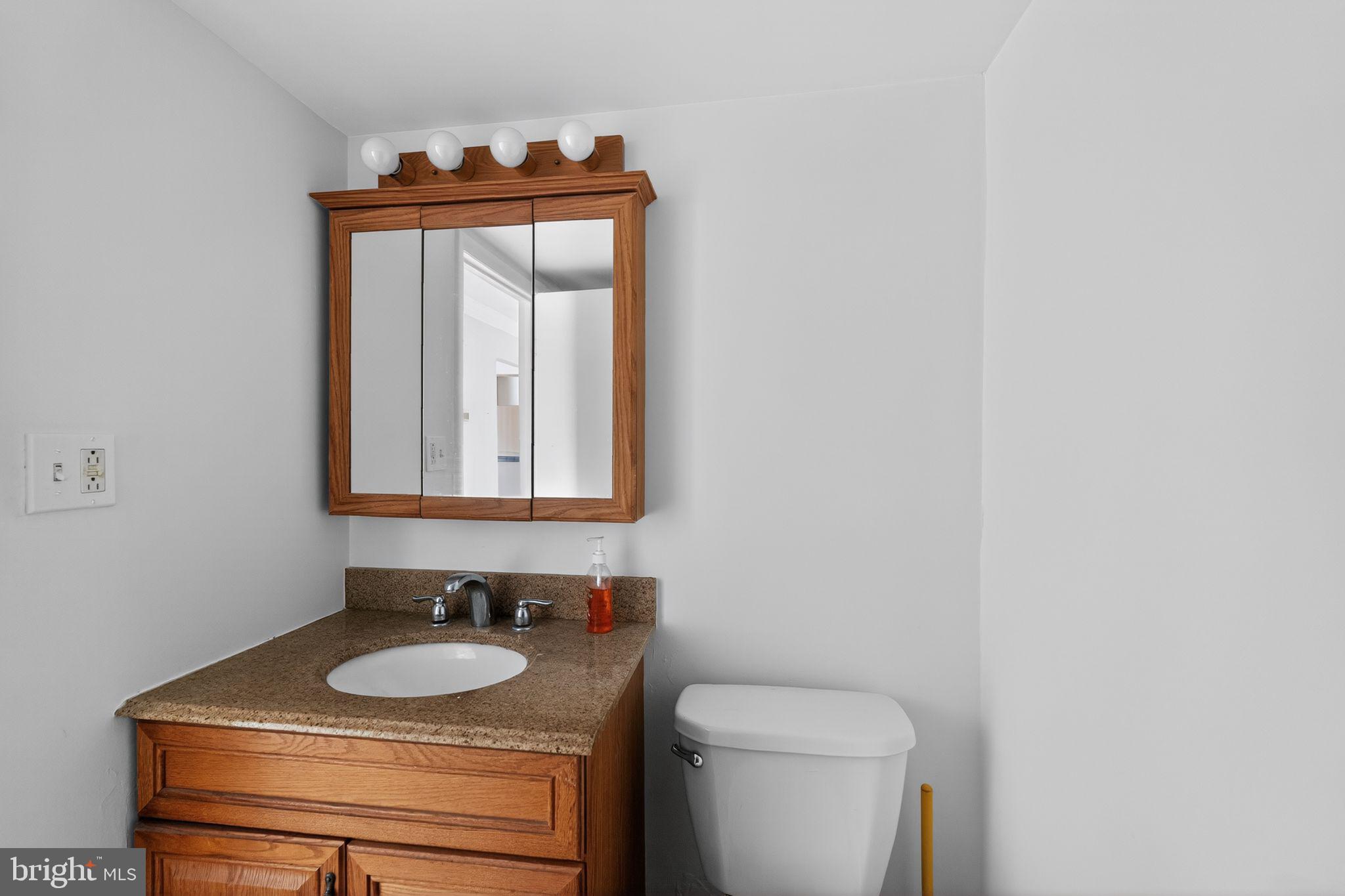 800 South Avenue, Unit B4 Secane, PA 19018 - Photo 13 of 16 a bathroom with a toilet sink and mirror