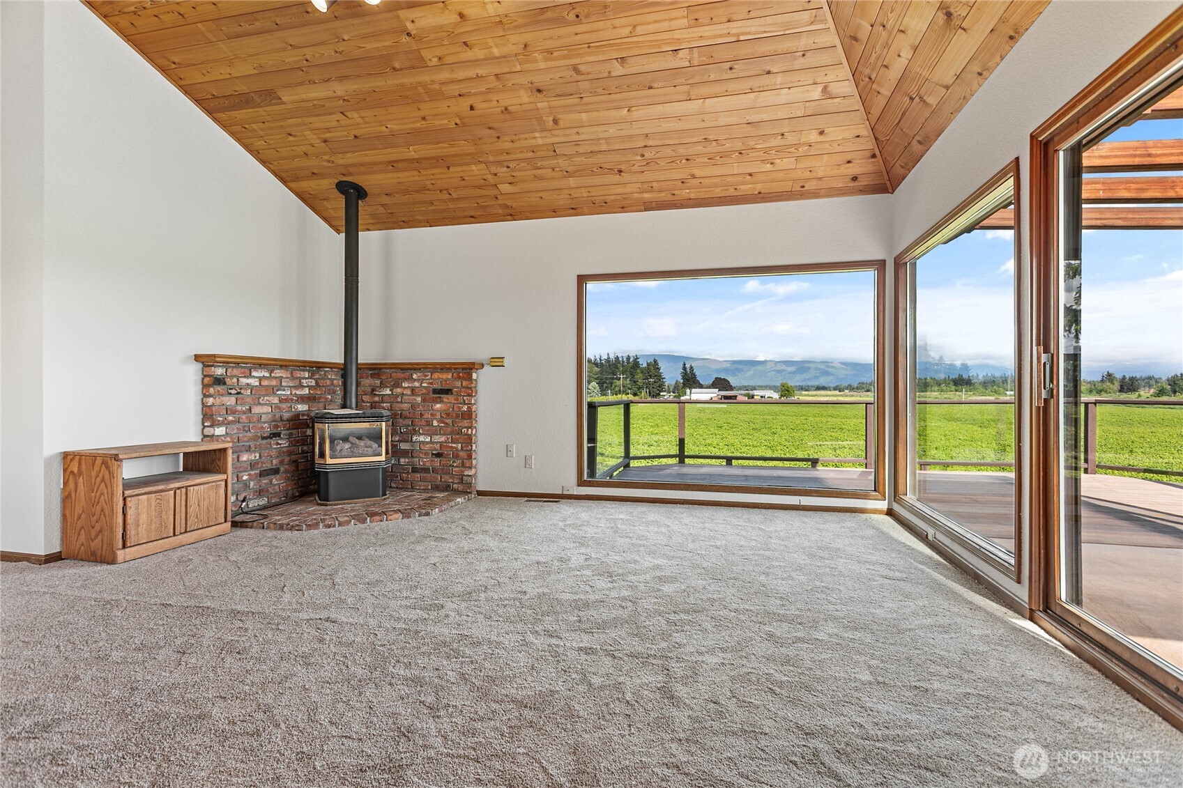 1133 East Pole Road Everson, WA 98247 - Photo 29 of 40 a view of an empty room with a fireplace and a large window