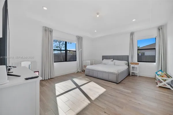 a spacious bedroom with a bed and a window
