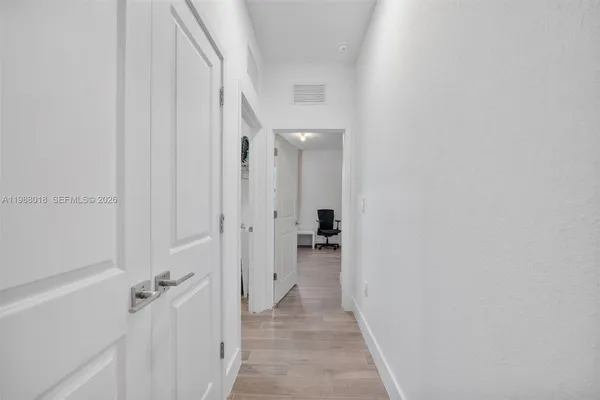 a view of a hallway with a wooden door