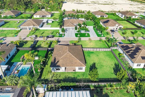 an aerial view of residential houses with outdoor space and street view
