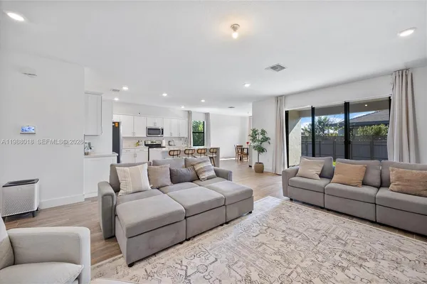 a living room with furniture and a large window