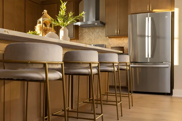a kitchen with stainless steel appliances granite countertop a refrigerator and cabinets
