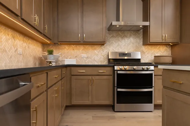 a kitchen with granite countertop cabinets and steel stainless steel appliances