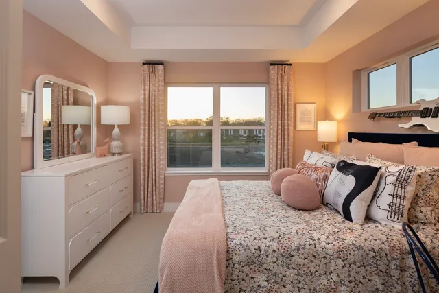a spacious bedroom with a bed and large windows