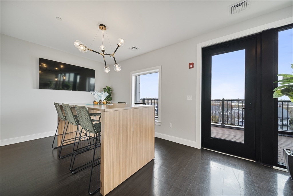 11 Walley Street, Unit 202 Boston, MA 02128 - Photo 22 of 24 a view of a dining room with furniture window and wooden floor