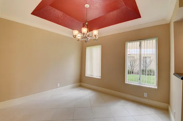 a view of a dining room with furniture and chandelier