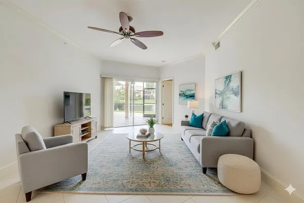 a view of a livingroom with a ceiling fan and window