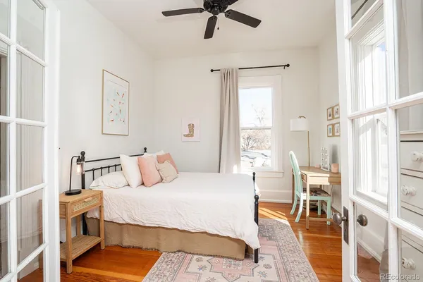 a bedroom with a bed and a window