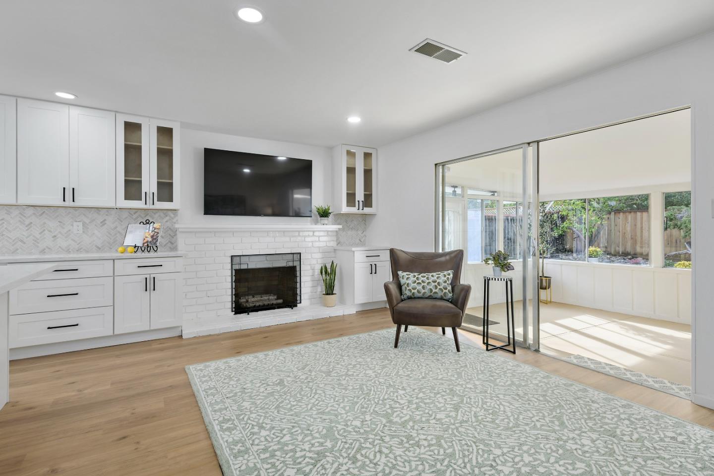 10275 Farallone Drive Cupertino, CA 95014 - Photo 11 of 17 a living room with furniture a flat screen tv and a fireplace