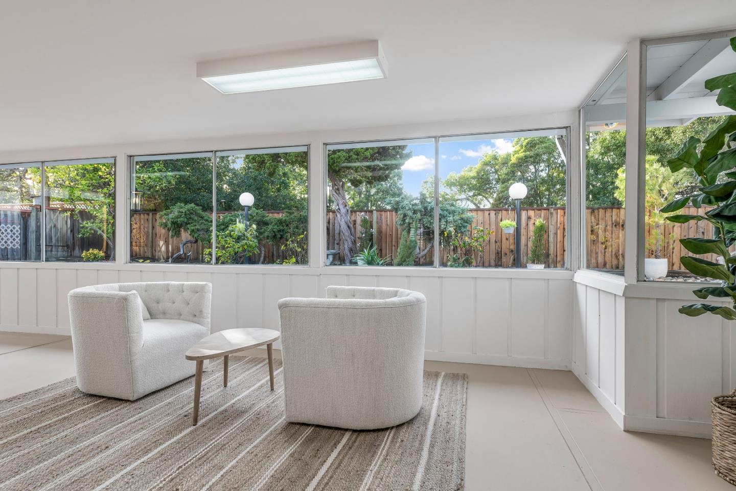 10275 Farallone Drive Cupertino, CA 95014 - Photo 15 of 17 a living room with large windows and a table